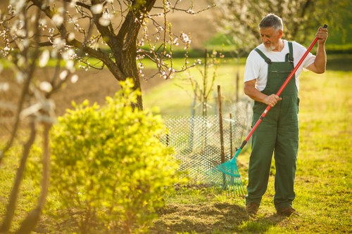 Garden maintenance workers discussing a task near a boundary